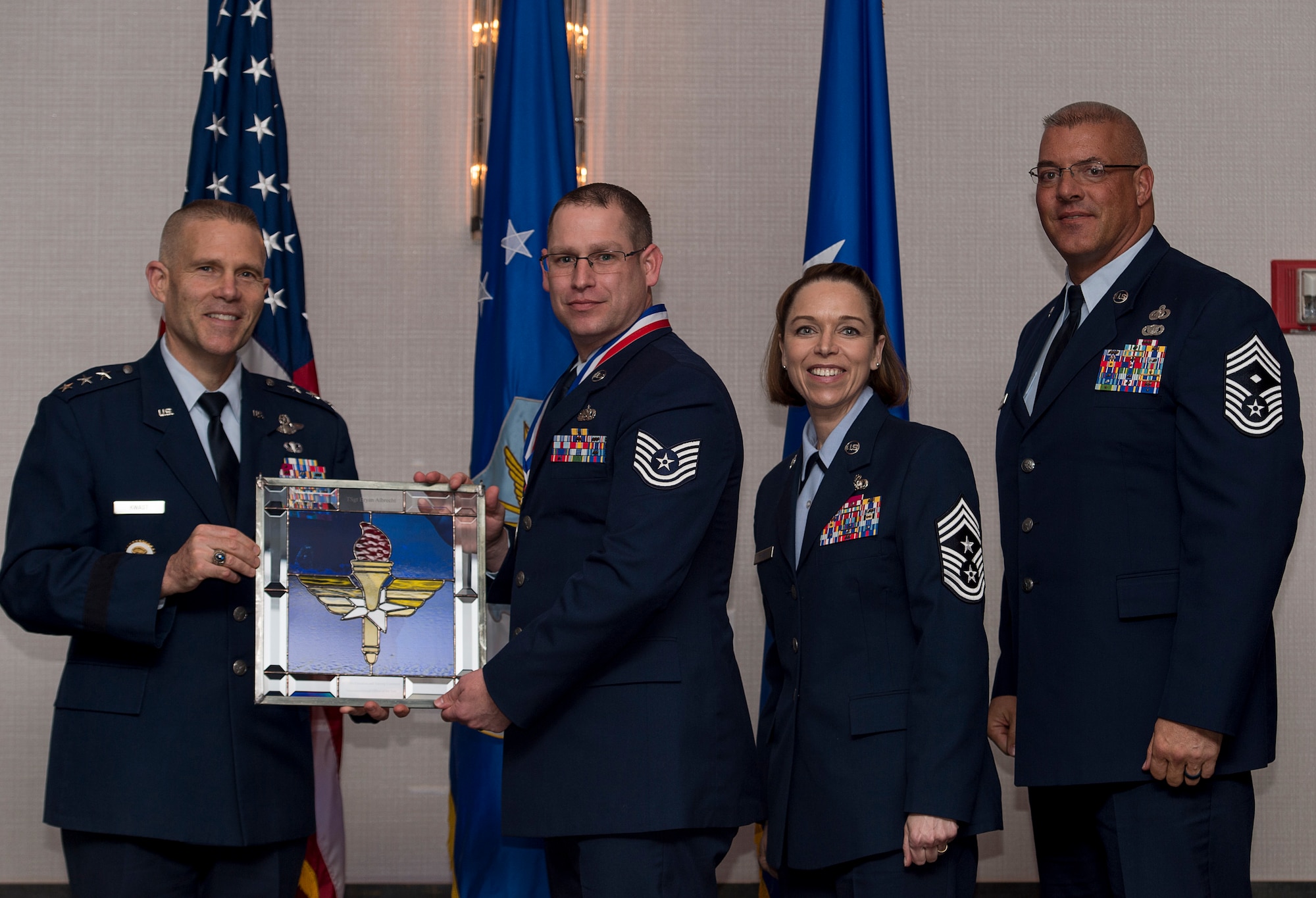 U.S. Air Force Tech. Sgt. Bryan S. Albrecht, noncommissioned officer in charge of Radar, Airfield, & Weather Systems assigned to the 14th Operations Support Squadron at Columbus Air Force Base, Miss., receives the Air Education and Training Command Non-Commissioned Officer of the Year Award from Lt. Gen. Steve Kwast, Commander of AETC during the AETC 12 Outstanding Airmen of the Year Awards banquet Feb. 22, 2018 in Orlando, Fla. Albrecht acted as Flight Chief for 9 months, managing 18 personnel, 770 inspections and 510 maintenance actions while also securing communications for 65,000 flights at AETC’s busiest airfield, directed 51 component distributions to four Major Commands, restoring navigation systems for five Wings and saved $622,000, as well as won Operation Group NCO of the Year. (U.S. Air Force photo by Staff Sgt. Kenneth W. Norman)