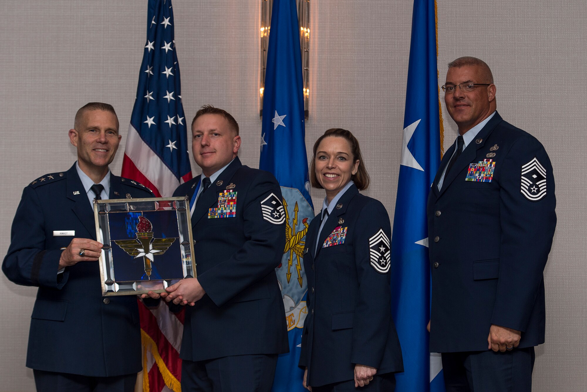 U.S. Air Force Master Sgt. Timothy S. Ogan, First Sergeant assigned to the Air Force Institute of Technology at Wright-Patterson Air Force Base, Ohio, receives the Air Education and Training Command First Sergeant of the Year Award from Lt. Gen. Steve Kwast, Commander of AETC during the AETC 12 Outstanding Airmen of the Year Awards banquet Feb. 22, 2018 in Orlando, Fla. Ogan won Air University First Sergeant of the Year, led18 fellow First Sergeants and 22 committees as President of the First Sergeant Council, as well as completed six credits towards his Master’s Degree. (U.S. Air Force photo by Staff Sgt. Kenneth W. Norman)