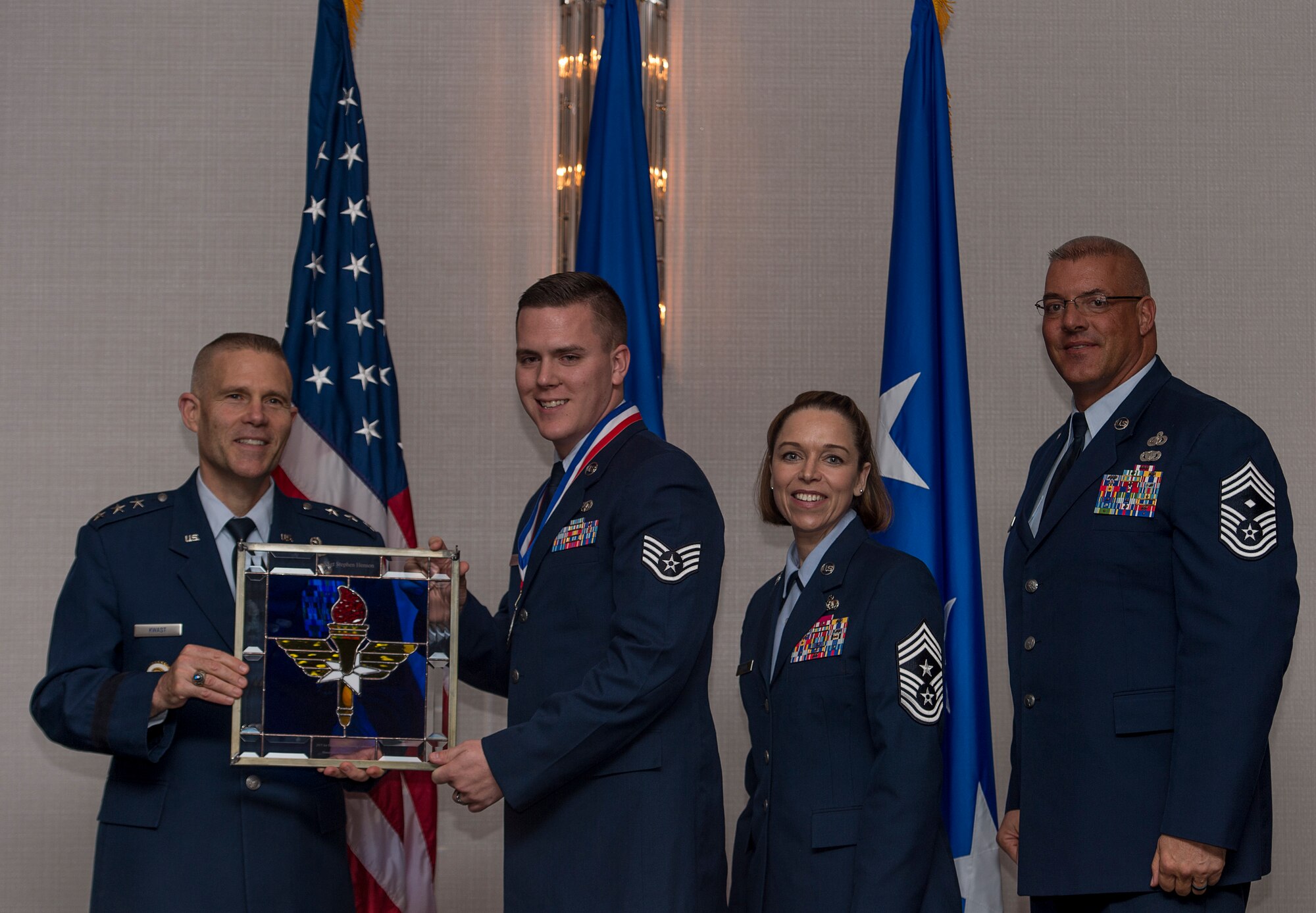 U.S. Air Force Staff Sgt. Stephen W. Hensen, a client systems supervisor and base Honor Guard member assigned to the Air Force Life Cycle Management Center at Maxwell-Gunter Air Force Base, Ala., receives the Chief Master Sergeant of the Air Force Base Honor Guard Member of the Year Award from Lt. Gen. Steve Kwast, commander of AETC, during the AETC 12 Outstanding Airmen of the Year Awards Banquet Feb. 22, 2018 in Orlando, Fla. Henson led 484 successful Honor Guard details traveling over 80,000 miles and dedicating 2,600 hours of his time; Earned Base Honor Guardsman for the first quarter; and Revised the base Honor Guard training plan, enhancing the skills of 20 fellow Honor Guardsmen. (U.S. Air Force photo by Staff Sgt. Kenneth W. Norman)