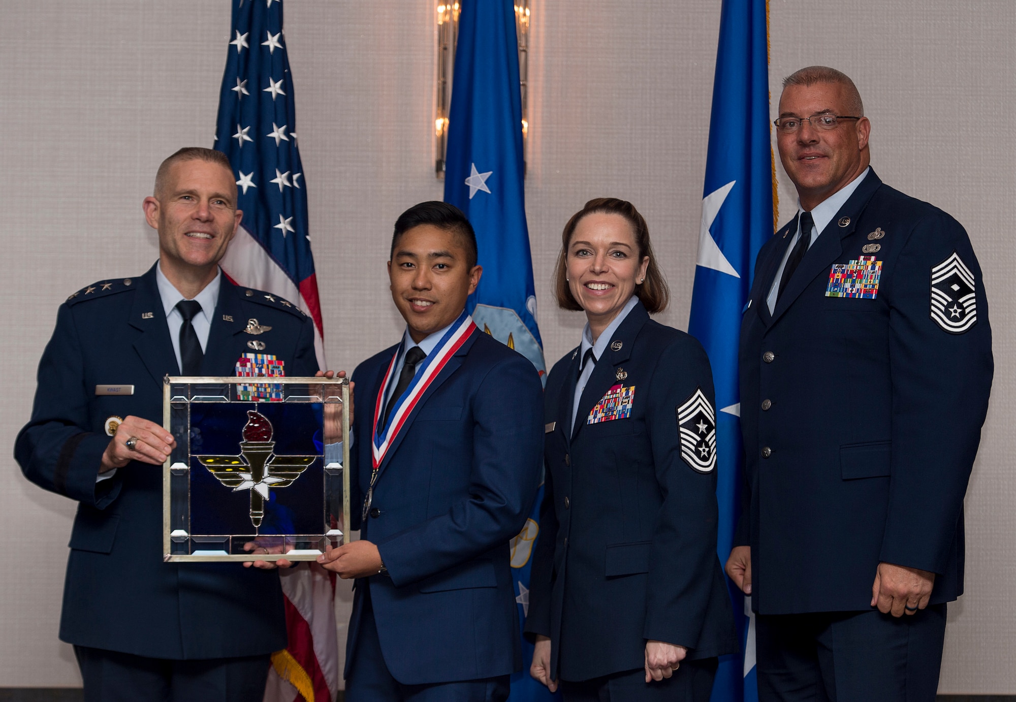 U.S. Air Force Capt. Ryan Caguillo, chief of command and control communications, assigned to the 81st Training Wing at Keesler Air Force Base, Miss., receives the Air Education and Training Command Company Grade Officer of the Year Award from Lt. Gen. Steve Kwast, Commander of AETC during the AETC 12 Outstanding Airmen of the Year Awards banquet Feb. 22, 2018 in Orlando, Fla. Caguillo deployed for nine months in which he managed 4,500 communication links that enabled seamless command and control. He coordinated 15 joint terminal air strikes, linking planning requirements with combat assets and destroying four ISIS headquarters, three improvised explosive devise factories and three drug refineries. Caguillo also organized 12,000 mission documents released to 60 nations, which enabled 25,000 sorties vital to Iraqi liberation from ISIS. (U.S. Air Force photo by Staff Sgt. Kenneth W. Norman)