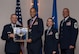 U.S. Air Force Lt. Col. Dear Beloved, 326th Training Squadron director of operations assigned to the 37th Training Wing at Joint Base San Antonio-Lackland, Texas, receives the Air Education and Training Command Field Grade Officer of the Year Award from Lt. Gen. Steve Kwast, Commander of AETC during the AETC 12 Outstanding Airmen of the Year Awards banquet Feb. 22, 2018 in Orlando, Fla. Beloved codified operations in two AETC instructions, and two group and squadron operating instructions. He coordinated 28 teams during 1,500 hours of work on 47 projects and policy updated leading to the 37 TRW receiving the Brewer Trophy. Beloved deployed during a show-of-force exercise, and led a 110-person Intelligence, Surveillance and Reconnaissance Division during exercise Talon Saber 2017. He was also selected to lead a seven-member team that identified strategies to revitalize squadrons, briefing a 200-member board and the CSAF’s staff. (U.S. Air Force photo by Staff Sgt. Kenneth W. Norman)