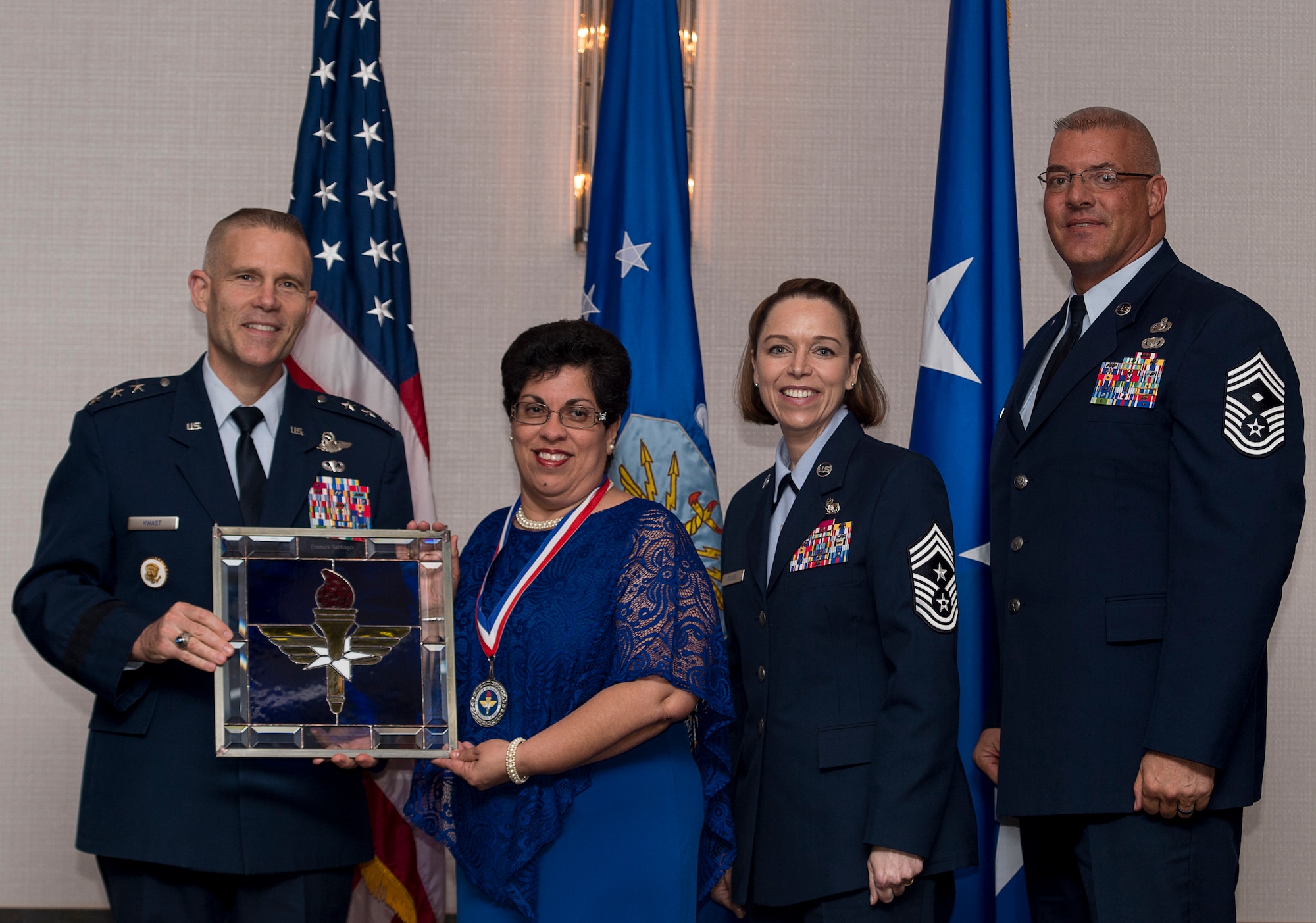 Frances Santiago, Identification Card Section Lead assigned to the 802nd Force Support Squadron at Joint Base San Antonio-Lackland, Texas, receives the 2017 Non-supervisory Civilian of the Year Award from Lt. Gen. Steve Kwast, Commander of AETC, during the AETC 12 Outstanding Airmen of the Year Awards banquet Feb. 22, 2018 in Orlando, Fla. Santiago won the prestigious Depart of Defense, Defense Manpower Data Center High Flyer award, restructured two site operations reducing customer wait times by 50 percent and earning a top 10 rank for office Air Force wide, as well as vetted, educated and terminated 811 Common Access and Identification Cards saving Air Force $8.7 million in erroneous Tricare benefits. (U.S. Air Force photo by Staff Sgt. Kenneth W. Norman)
