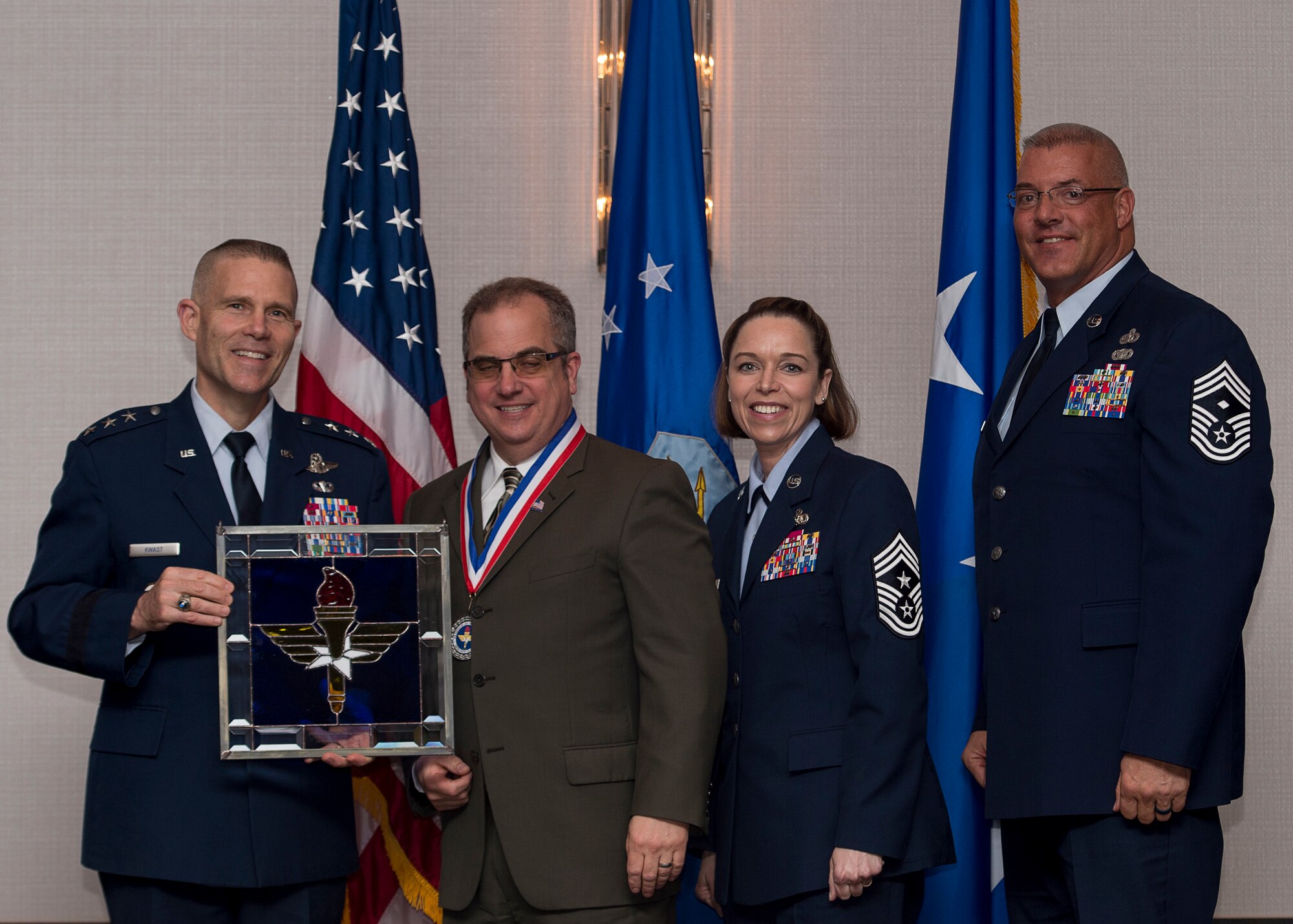 Joseph M. DiMisa, Instructor of Environmental Management at the Air Force Institute of Technology at Wright-Patterson Air Force Base, Ohio, receives the 2017 Non-supervisory Civilian of the Year Award from Lt. Gen. Steve Kwast, Commander of AETC, during the AETC 12 Outstanding Airmen of the Year Awards banquet Feb. 22, 2018 in Orlando, Fla. DiMisa directed eight AFIT Civil Engineering courses, while teaching 130 instructional hours in 25 courses, educating 783 Department of Defense engineers, developed seven Air Force level on-demand environmental management mini-courses, which are used 8,000 times per month and saved the Air Force $400,000 annually, as well as authored and published “Ecological Restoration of the Midwest” a 296 page book and a first of its kind for the Midwest. (U.S. Air Force photo by Staff Sgt. Kenneth W. Norman)