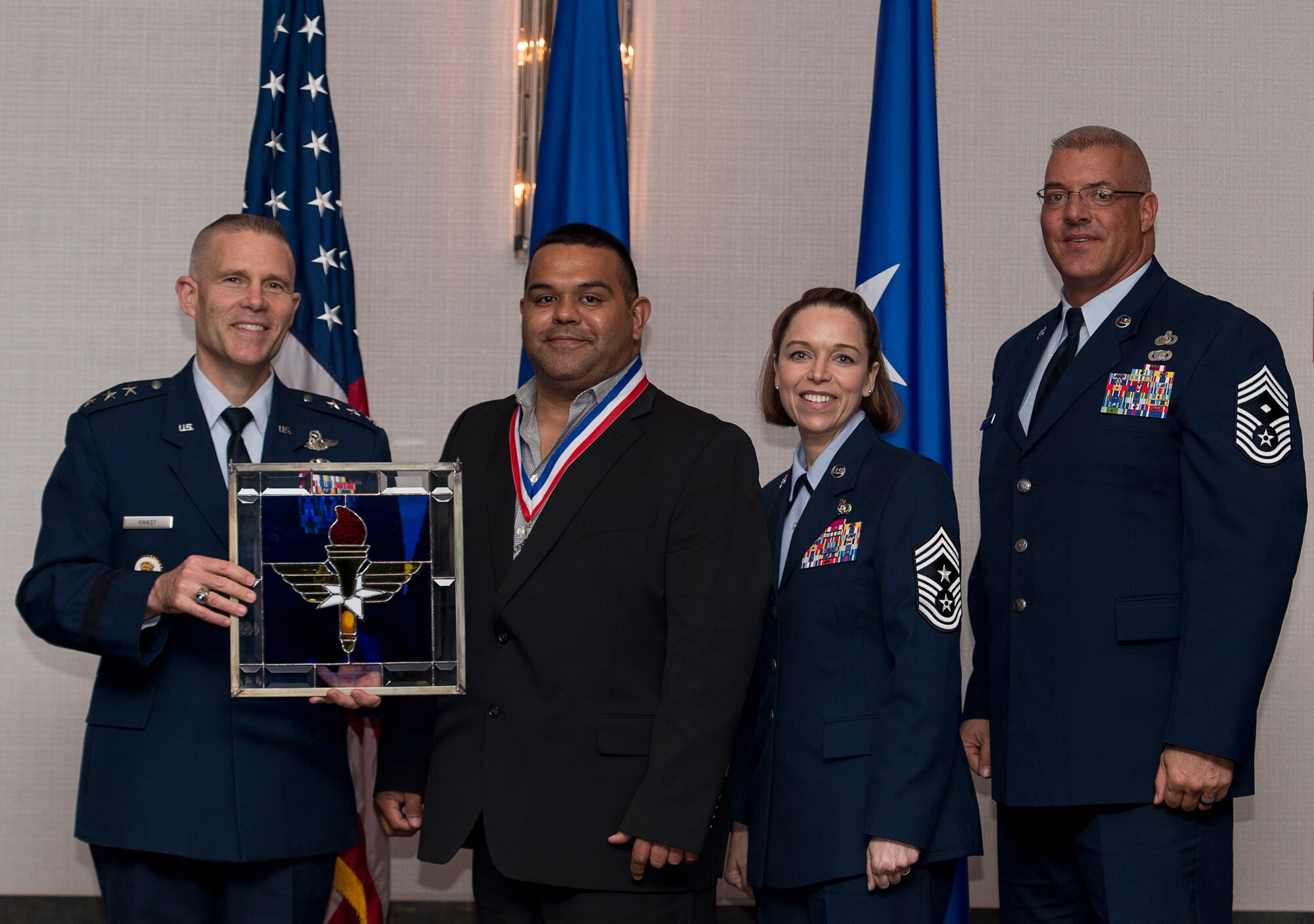 Ramiro Solis, Maintenance Program Supervisor assigned to the 97th Maintenance Group at Altus Air Force Base, Oklahoma, receives the 2017 Supervisory Civilian of the Year Award from Lt. Gen. Steve Kwast, Commander of Air Education and Training Command, during the AETC 12 Outstanding Airmen of the Year Awards banquet, Feb. 22, 2018, in Orlando, Fla. Solis executed $9.2 million KC-46 Pegasus support equipment, which processed 1,874 pieces and guaranteed the Wing’s new mission success, identified a critical KC-46 potable water shortfall with a solution that was implemented fleet-wide, and orchestrated a city-wide fundraiser to replace the youth softball and safety equipment, raising $3,500 and providing for 80 children. (U.S. Air Force photo by Staff Sgt. Kenneth W. Norman)