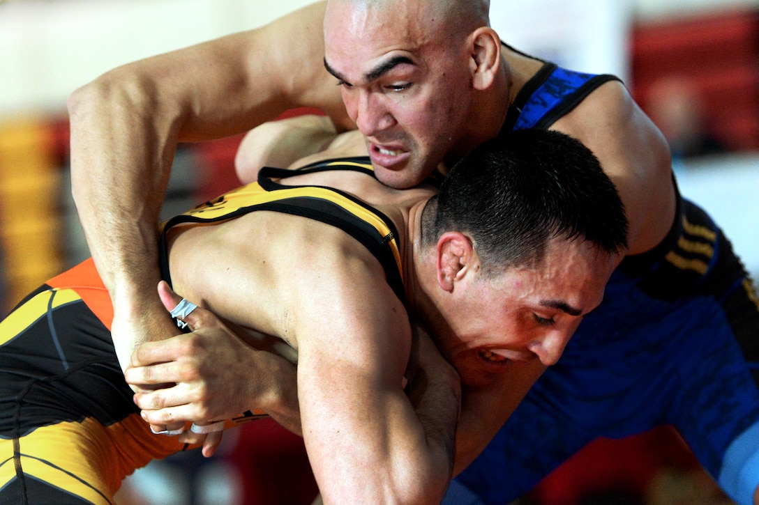Marine Corp Lance Cpl. German Diaz, ties-up Army 1st Lt. Marco Lara in the 67 kg weight class.
