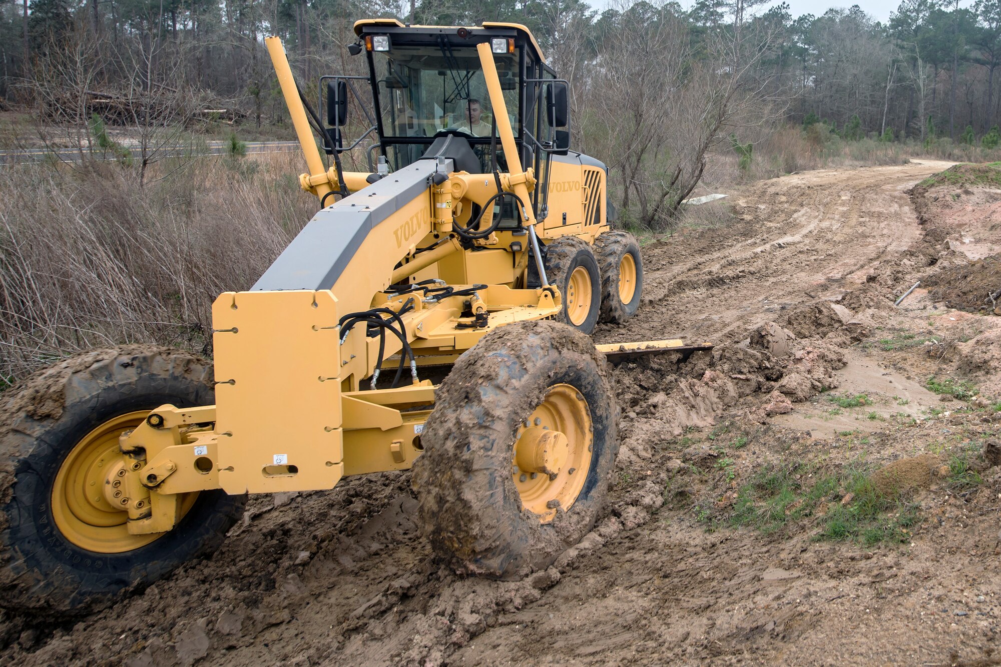 Staff Sgt. Elliot Westerman, 23d Civil Engineer Squadron (CES) heavy equipment operator, pushes dirt with a grader, Feb. 15, 2018, at Moody Air Force Base, Ga. Airmen from the 23d CES participated in a Prime Base Engineer Emergency Force training day to prepare for some of the wartime tasks they could encounter while in a deployed environment. (U.S. Air Force photo by Airman Eugene Oliver)