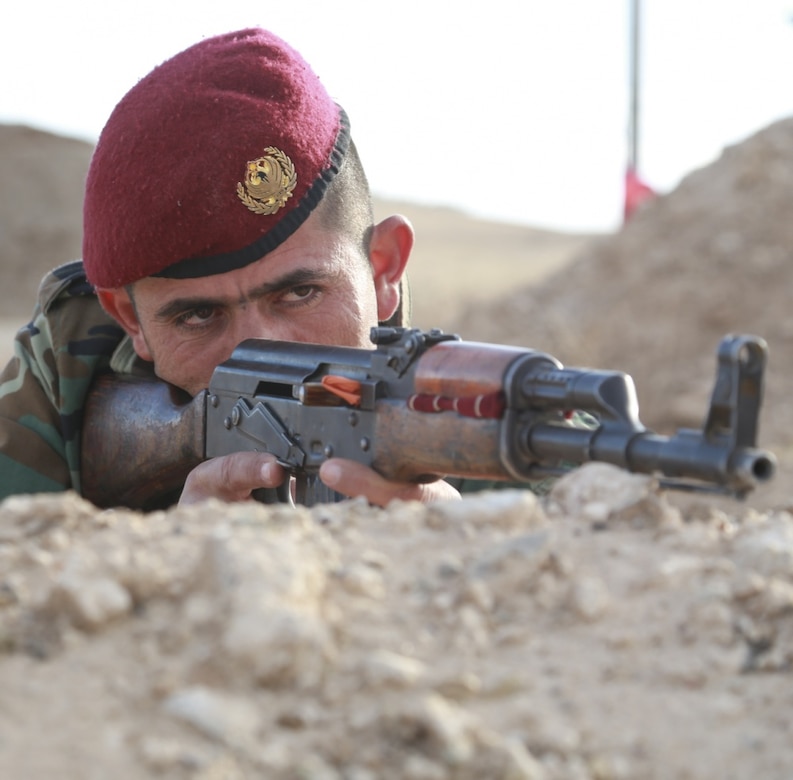 A U.S.-led coalition partner force member pulls security during basic infantry training led by German army trainers near Irbil, Iraq