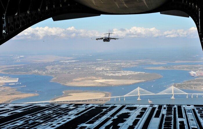 A C-17 Globemaster III from Joint Base Charleston flies behind another C-17 over the Arthur Ravenel Jr. Bridge in Charleston, S.C., Feb. 24, 2018.