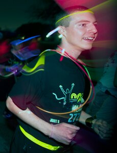 A participant gets his glow on during the Glow In The Park 5K fun run at MacArthur Field at Joint Base San Antonio-Fort Sam Houston Feb. 24.