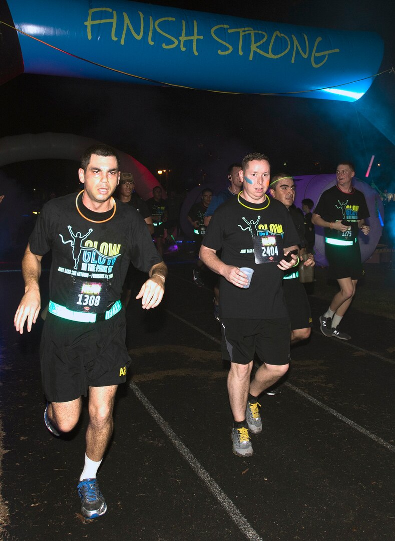 Participants in the annual "Glow In The Park" 5K fun run at MacArthur Park at Joint Base San Antonio-Fort Sam Houston "finish strong" Feb. 24.