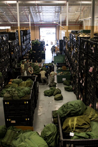 Airmen from the 23d Logistics Readiness Squadron (LRS) move a crate filled with A-bags in preparation for a Phase 1 exercise, Feb. 23, 2018, at Moody Air Force Base, Ga. The 23d LRS prepped approximately 400 A-bags, which consisted of items essential for deploying Airmen. This helped ensure the success of the Airmen participating in the exercise, which tested operations, maintenance and logistics to demonstrate the 23d Wing’s ability to rapidly deploy to meet the needs of combatant commanders. (U.S. Air Force photo by Airman 1st Class Erick Requadt)