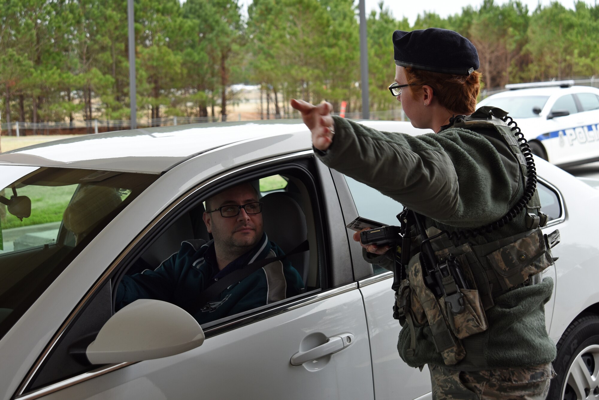 U.S. Air Force Airman 1st Class Andrea Pearson, 20th Security Forces Squadron entry controller, gives a base visitor directions at Shaw Air Force Base, S.C., Feb. 13, 2018.
