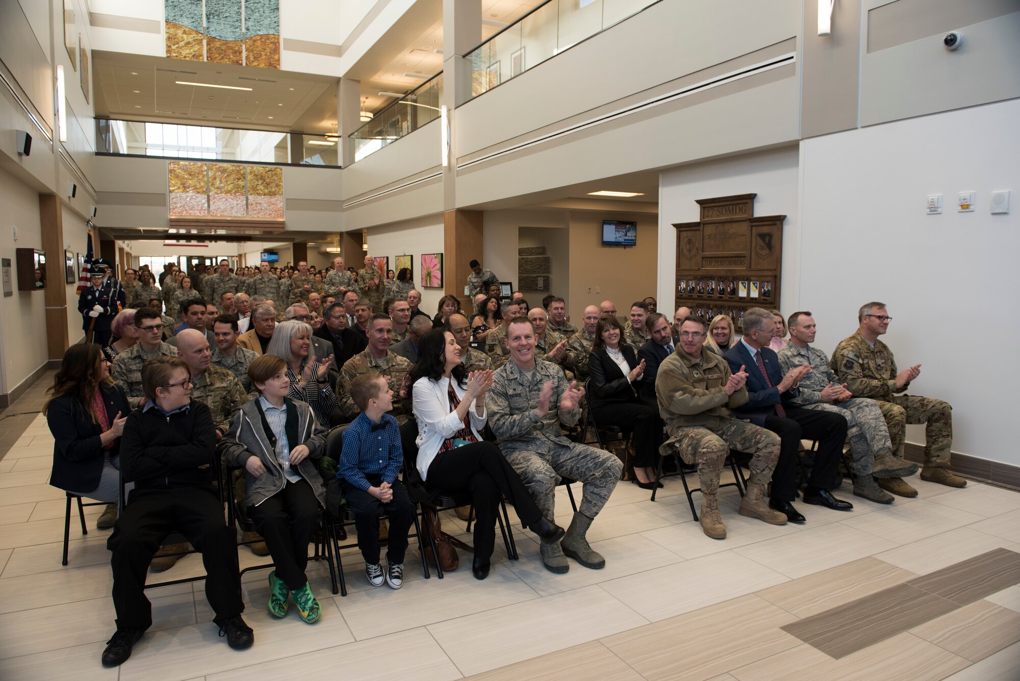 Military members and civilians applaud during the 27th Special Operations Medical Group building ribbon cutting ceremony at Cannon Air Force Base, N.M., Feb. 23, 2018. This upgrade has been planned for the last few years. The ground-breaking ceremony was July of 2015 and now, nearly three years later, the building complete and open for patients. (U.S. Air Force photo by Staff Sgt. Michael Washburn/Released)