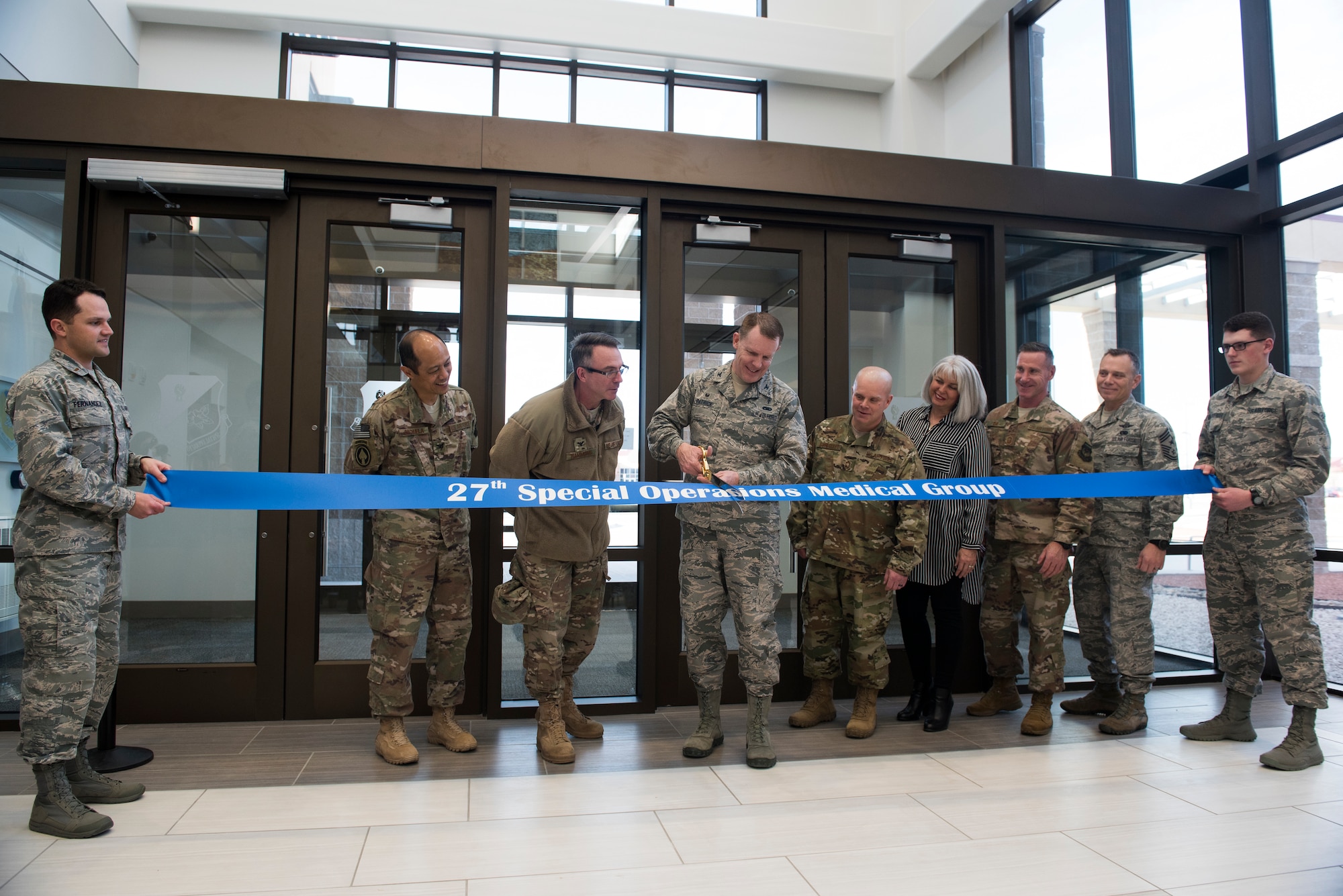 Col. Christopher Patrick, 27th Special Operations Medical Group commander, cuts the formal ribbon during the 27th SOMDG building ribbon cutting ceremony at Cannon AFB, N.M., Feb. 23, 2018. The upgrade to the new medical group facility is just one more way that Cannon is committed to being a premier installation. (U.S. Air Force photo by Staff Sgt. Michael Washburn/Released)