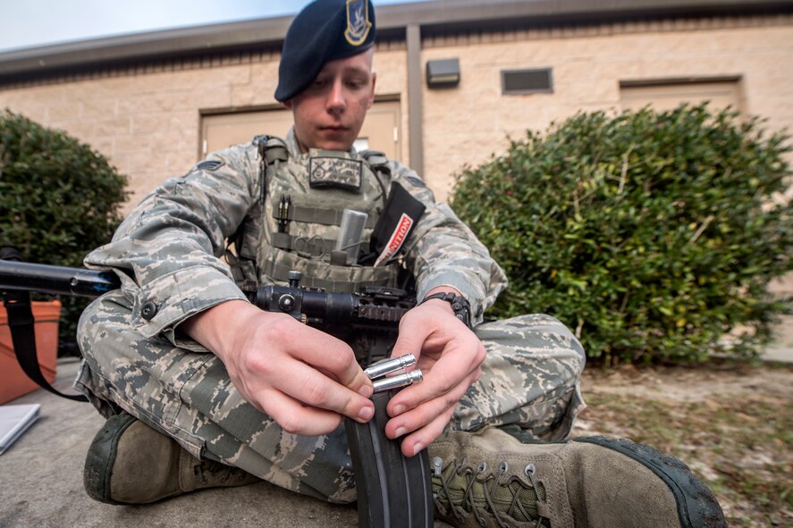 Senior Airman Adam Irwin, 23d Security Forces Squadron installation patrolman, loads simulated bullets into a magazine, Feb. 22, 2018, at Moody Air Force Base, Ga.  The Shoot, move, communicate training event is designed to test participants on their ability to move from barricade to barricade as a team. To be successful, one member provided covering fire while others advanced on the enemy, then retreated from the scenario while they maintained cover fire. Security Forces members could employ these tactics anytime they’re under enemy fire.
(U.S. Air Force photo by Airman Eugene Oliver)