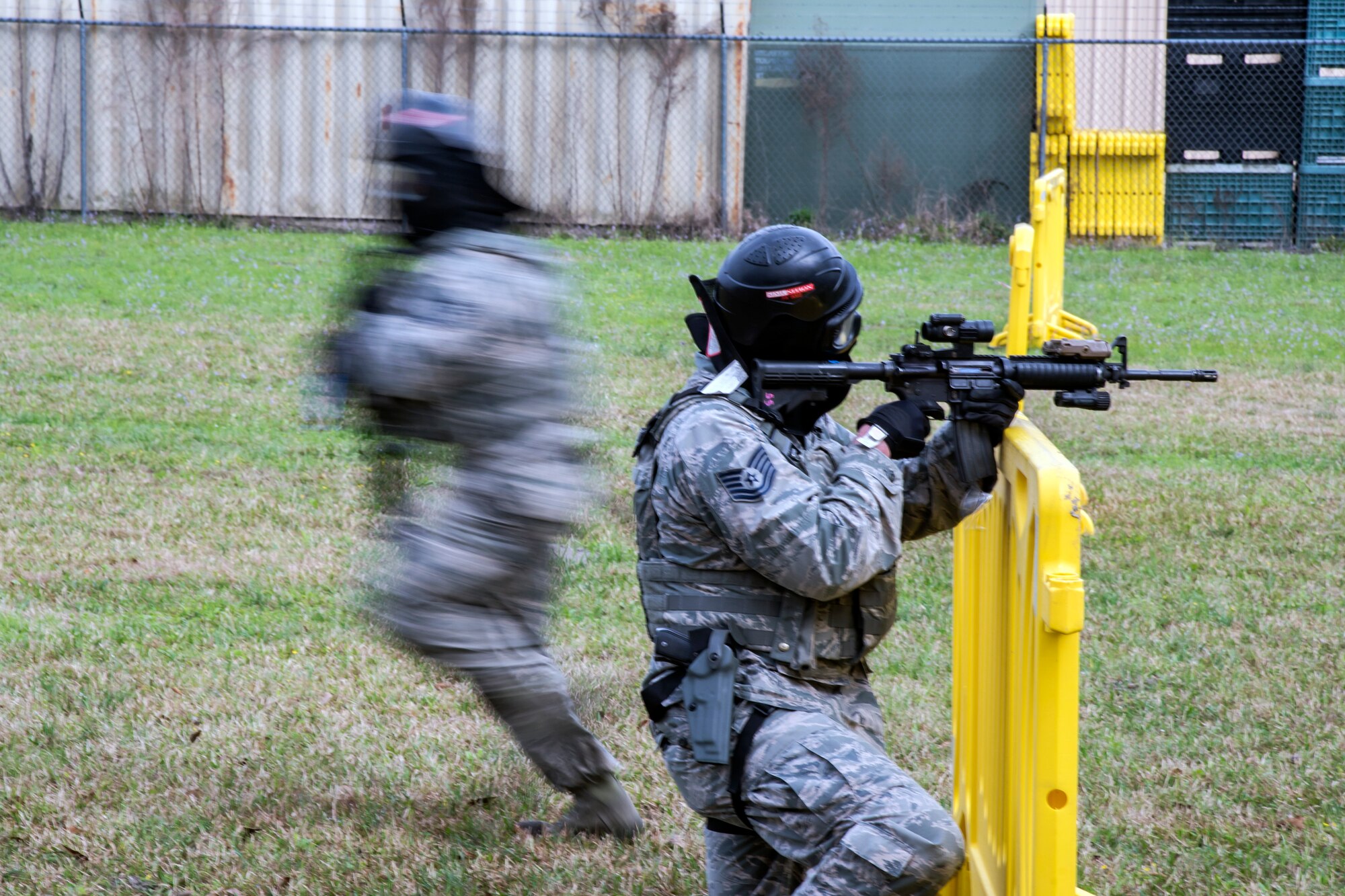 Tech Sgt. Stephen O’Hara, right, 23d Security Forces Squadron flight chief, shoots cover fire for Tech Sgt. Darryl Apiche, 23d Security Forces Squadron kennel master, , Feb. 22, 2018, at Moody Air Force Base, Ga.  The Shoot, move, communicate training event is designed to test participants on their ability to move from barricade to barricade as a team. To be successful, one member provided covering fire while others advanced on the enemy, then retreated from the scenario while they maintained cover fire. Security Forces members could employ these tactics anytime they’re under enemy fire. (U.S. Air Force photo by Airman Eugene Oliver)