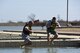 U.S. Air Force Col. Alex Ganster, 17th Training Group commander, and U.S. Army Lt. Col. Yukio Kuniyuki, 344th Military Intelligence Battalion commanding officer, take the first jump into Lake Nasworthy to start the swim portion of the Polar Bear Plunge in San Angelo, Texas, Feb. 24, 2018. Despite it being 72 degrees out, many participants said that the water was chilly. (U.S. Air Force photo by Airman 1st Class Seraiah Hines/Released)