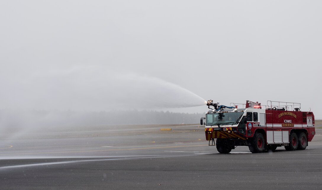 McKay Neel, McChord’s newest Pilot for a Day participant, sprays water out of a fire truck during a McChord Field tour at Joint Base Lewis-McChord, Wash., Feb. 20, 2018. McKay also saw a demonstration by military working dogs, learned about survival, evasion, resistance and escape at SERE training, flew a C-17 Globemaster III simulation and toured an actual C-17 during his visit. (U.S. Air Force photo by Senior Airman Tryphena Mayhugh)