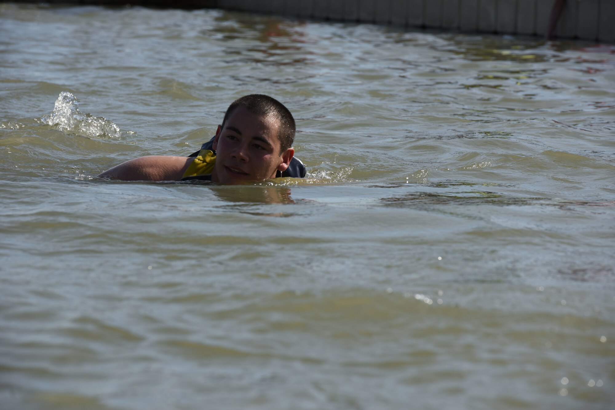 U.S. Army Pvt. Crecencio Yennie, 344th Military Intelligence Battalion trainee, swims in Lake Nasworthy after a second plunge during the Polar Bear Plunge event hosted by the 17th Force Support Squadron at Lake Nasworthy in San Angelo, Texas, Feb. 24, 2018. Being a Minnesota native, Yennie said he found the water refreshing and not at all that cold. (U.S. Air Force photo by Airman 1st Class Seraiah Hines/Released)