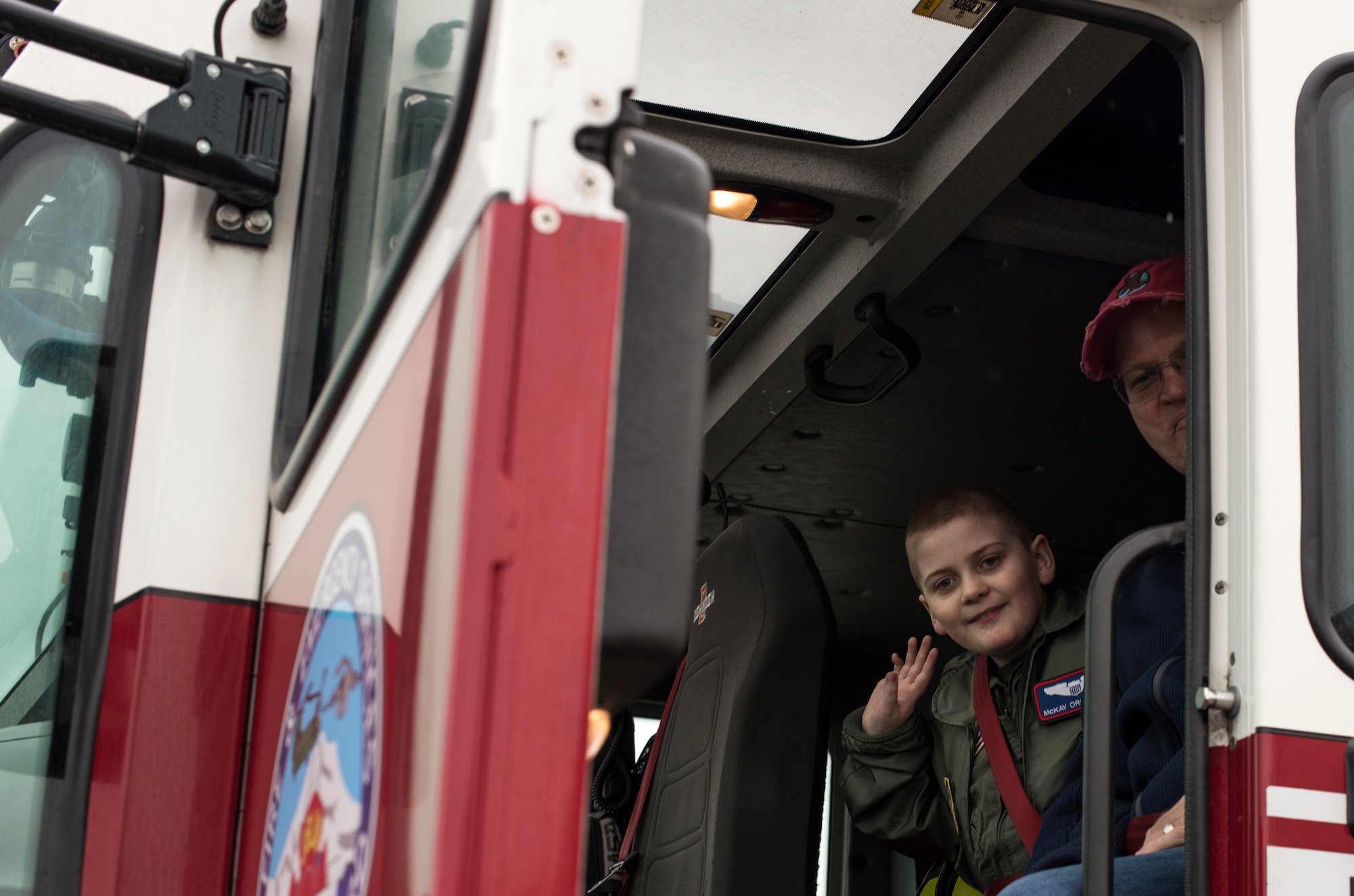 McKay Neel, McChord’s newest Pilot for a Day participant, sits inside a fire truck with his dad during a tour of McChord Field at Joint Base Lewis-McChord, Wash., Feb. 20, 2018. The Pilot for a Day program invites children with serious or chronic conditions of all ages, military or civilian, to be a guest at the 62nd Airlift Wing and one of McChord Field’s flying squadrons for a day. (U.S. Air Force photo by Senior Airman Tryphena Mayhugh)