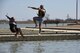 U.S. Air Force Chief Master Sgt. Daniel Stein, 17th Training Group superintendent, and Col. Alex Ganster, 17th TRG commander, represent the 17th TRG during the Polar Bear Plunge event hosted by the 17th Force Support Squadron at Lake Nasworthy in San Angelo, Texas, Feb. 24, 2018. After taking the plunge, service members could warm up by a fire while roasting s’mores. (U.S. Air Force photo by Airman 1st Class Seraiah Hines/Released