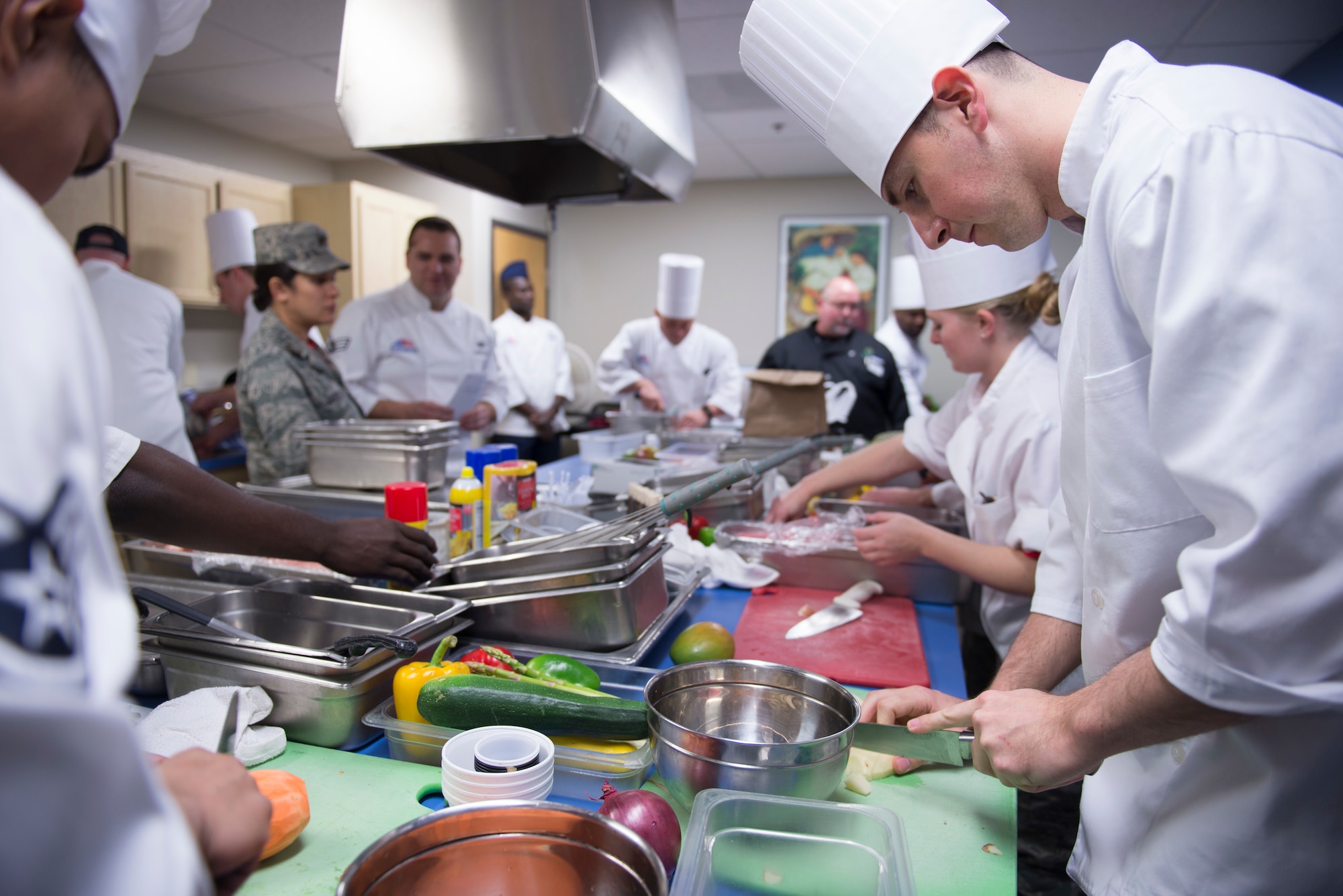 Chefs square off against each other by preparing meals in the Community Commons kitchen during the 2018 Grill Master competition at Luke Air Force Base, Ariz., Feb. 23, 2018. The Grill Master competition invited teams of two Airmen from units across the base to cook the best meal they could make out of fresh ingredients and a unique secret ingredient assigned to each team. (U.S. Air Force photo/Senior Airman Ridge Shan)