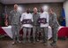 Chief Master Sgt. Todd Kirsch, Col. Robert Sylvester, and Maj. Maritzel Castrellon, judges for the 2018 Grill Master competition, pose with the winners of the competition, Staff Sgt. Victor McKinnon, 607th Air Control Squadron surveillance technician and Staff Sgt. Justin Williams, 607th ACS weapons director at Luke Air Force Base, Ariz., Feb. 23, 2018. McKinnon and Williams beat out four other two-man teams in the competition, which required them to cook a meal with one meat and two sides, while incorporating a secret ingredient. (U.S. Air Force photo/Senior Airman Ridge Shan)