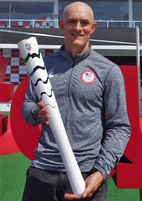 Team doctor poses for photo at Olympic games.