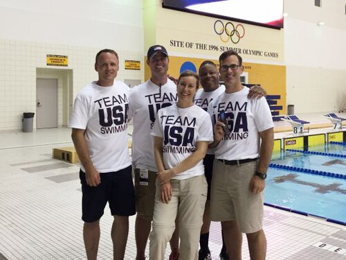 Sports medicine doctor poses with team members.