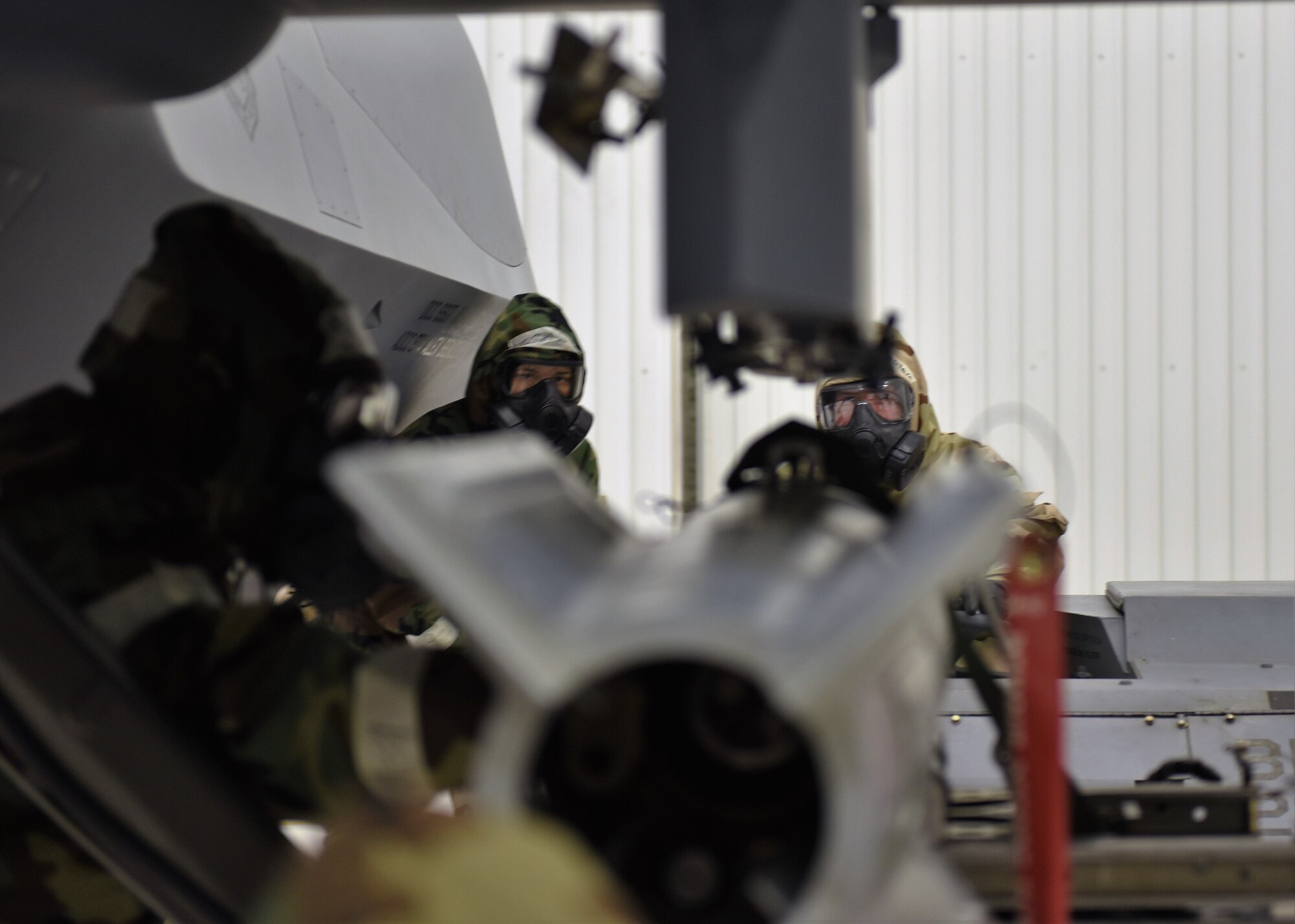 Airmen from the 49th Maintenance Group load weapons onto a MQ-9 Reaper during a phase II exercise at Holloman Air Force Base, N.M., Feb. 22, 2018. This exercise is a first among remotely piloted aircraft bases and the 49th MXG reached out Osan Air Base for support. (U.S. Air Force photo by Staff Sgt. Timothy Young)