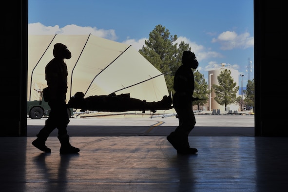 Airmen from the 49th Maintenance Group litter carry a simulated casualty during a phase II exercise at Holloman Air Force Base, N.M., Feb. 22, 2018. The participating Airmen’s training included donning mission oriented protective posture gear, conducting SABC to simulated injuries while keeping accountability of each other. (U.S. Air Force photo by Staff Sgt. Timothy Young)