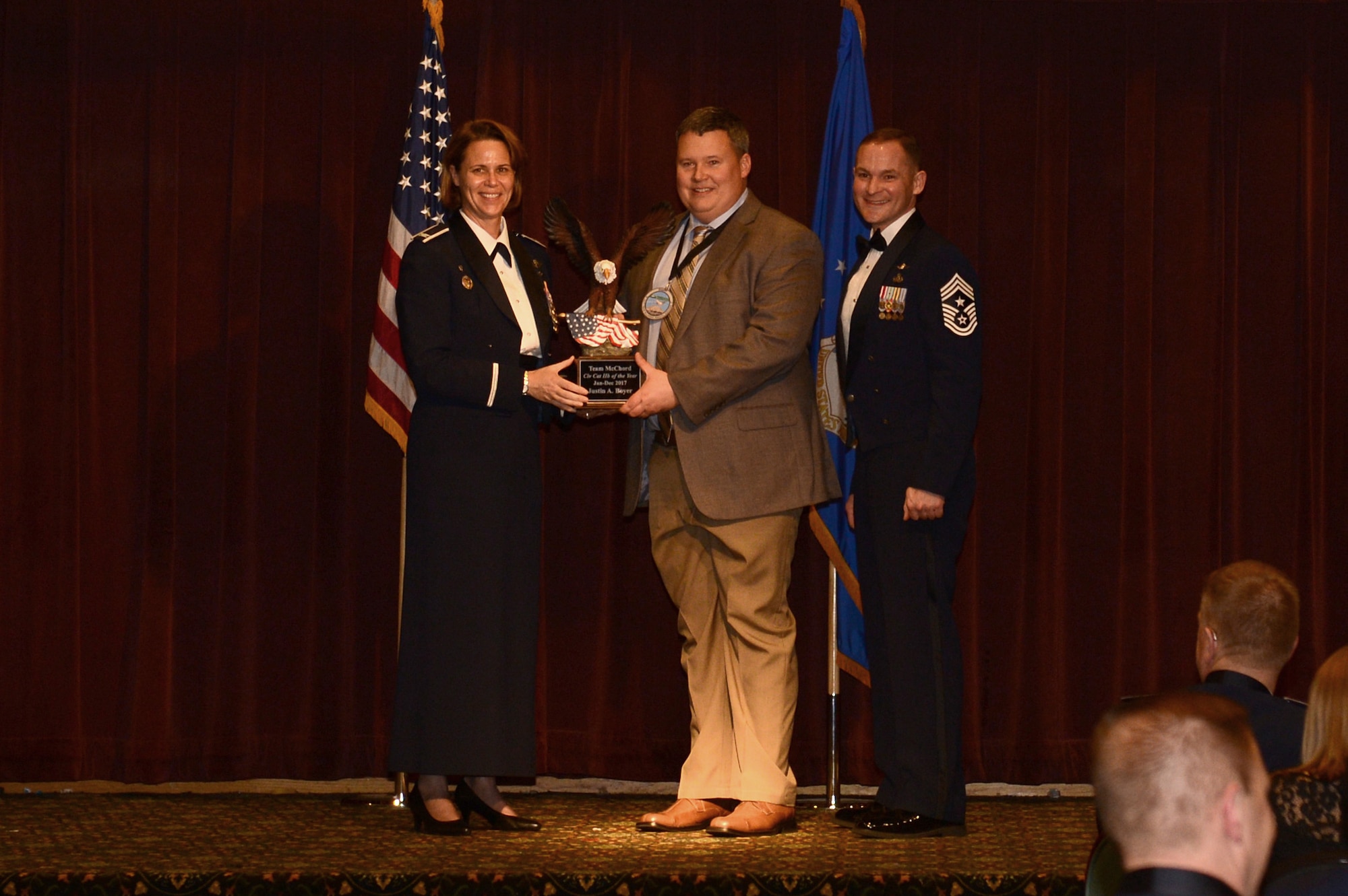 Justin Boyer, 62nd Airlift Wing, Maintenance squadron, receives an award for the Civilian Category IIB at the 2017 Team McChord Annual Awards Banquet at the McChord Field Club, Joint Base Lewis-McChord, Wash., Feb. 23, 2018. The annual awards included both the civilian and military members of Team McChord.
