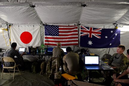U.S. Air Force (USAF), Koku Jieitai (Japan Air Self-Defense) and Royal Australian Air Force (RAAF) members utilize a central command information tent as a HUB to perform logistical re-supply, medical evacuation, troop movement and humanitarian assistance during exercise COPE NORTH 18 at Tinian, U.S. Commonwealth of the Northern Marianas Islands, Feb. 21. Through exercises and engagements during COPE NORTH, USAF, Koku Jieitai and RAAF increase interoperability for humanitarian assistance/disaster relief operations. (U.S. Air Force photo by Airman 1st Class Christopher Quail)