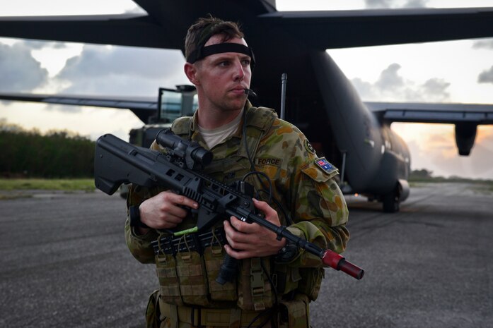 A Royal Australian Air Force security forces member protects an C-130J Super Hercules during a training scenario at exercise COPE NORTH 18 on Tinian, U.S. Commonwealth of the Northern Marianas Islands, Feb. 20. COPE NORTH enables U.S. and allied forces to train humanitarian assistance/disaster relief operations from austere operating bases, enhancing our capacity and capability to respond in times of crisis. (U.S. Air Force photo by Airman 1st Class Christopher Quail)