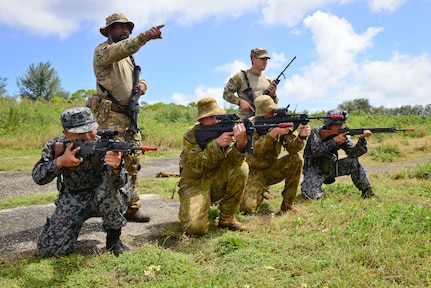 U.S. Air Force (USAF), Koku Jieitai (Japan Air Self-Defense) and Royal Australian Air Force (RAAF) members defend a perimeter during a training scenario in exercise COPE NORTH 18 at Tinian, U.S. Commonwealth of the Northern Marianas Islands, Feb. 20. Through exercises and engagements during COPE NORTH, USAF, Koku Jieitai and RAAF increase interoperability for humanitarian assistance/disaster relief operations. (U.S. Air Force photo by Airman 1st Class Christopher Quail)