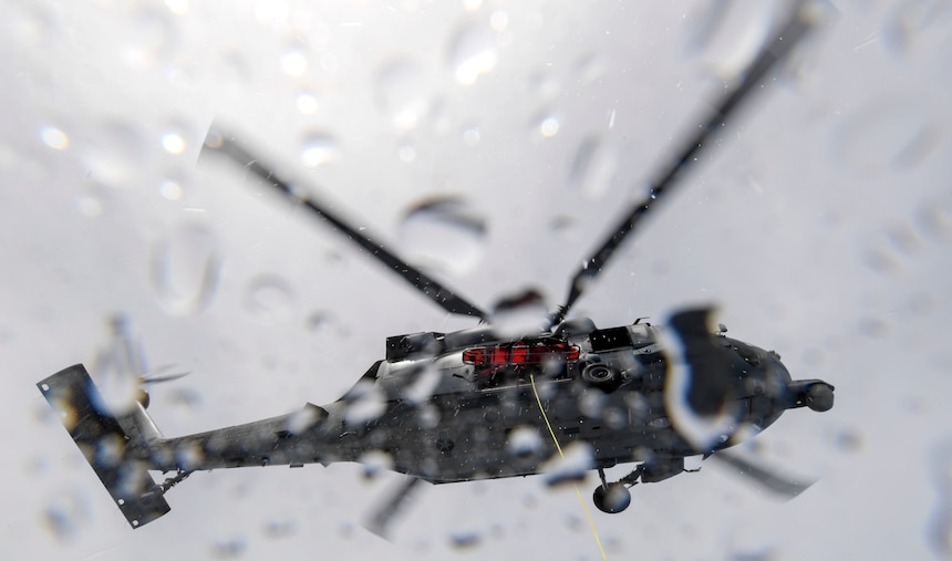 An MH-60S Sea Hawk helicopter, assigned to Helicopter Sea Combat Squadron (HSC) 25, hovers above a Mark VI patrol boat, assigned to Coastal Riverine Group 1, during a joint search and rescue exercise with U.S. Coast Guard Sector Guam, Feb. 23, 2018.