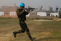 A Bangladesh Army soldier of the Para-Commando Brigade runs to secure a drop zone during a rehearsal for a demonstration as part of Exercise Shanti Doot 4 in Bangladesh.