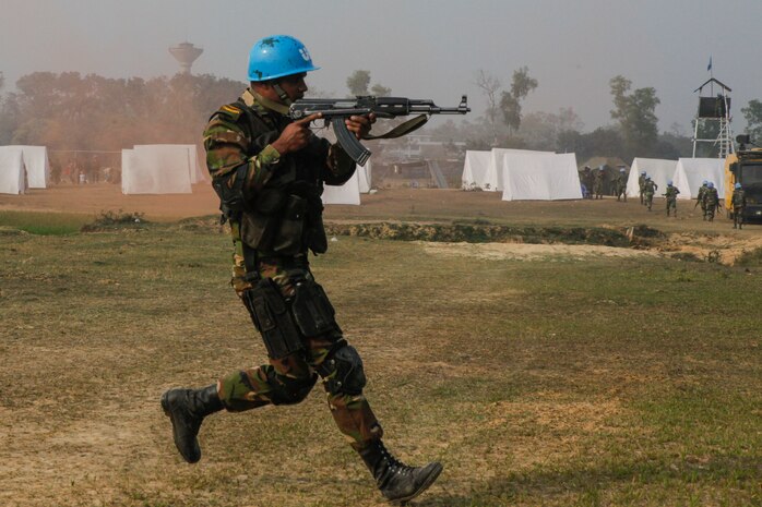 A Bangladesh Army soldier of the Para-Commando Brigade runs to secure a drop zone during a rehearsal for a demonstration as part of Exercise Shanti Doot 4 in Bangladesh.