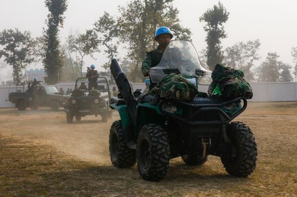 A column of Bangladesh army soldiers in vehicles return to their encampment after a rehearsal for a demonstration as part of Exercise Shanti Doot 4 in Bangladesh.
