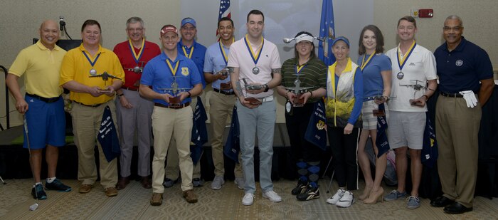 The 437th Airlift Wing annual award winners stand with Col. Jimmy Canlas, left, 437th AW commander, Chief Master Sgt. Jack Johnson Jr., right, Supreme Allied Command Transformation senior enlisted leader and Chief Master Sgt. Jennifer Kersey, 4th from right, 437th AW command chief during the 437th AW annual award ceremony at the Charleston Club, Joint Base Charleston, S.C., Feb. 23, 2018.
