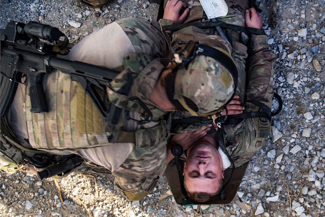 An Air Force pararescueman provides medical aid to a simulated casualty during a training exercise.