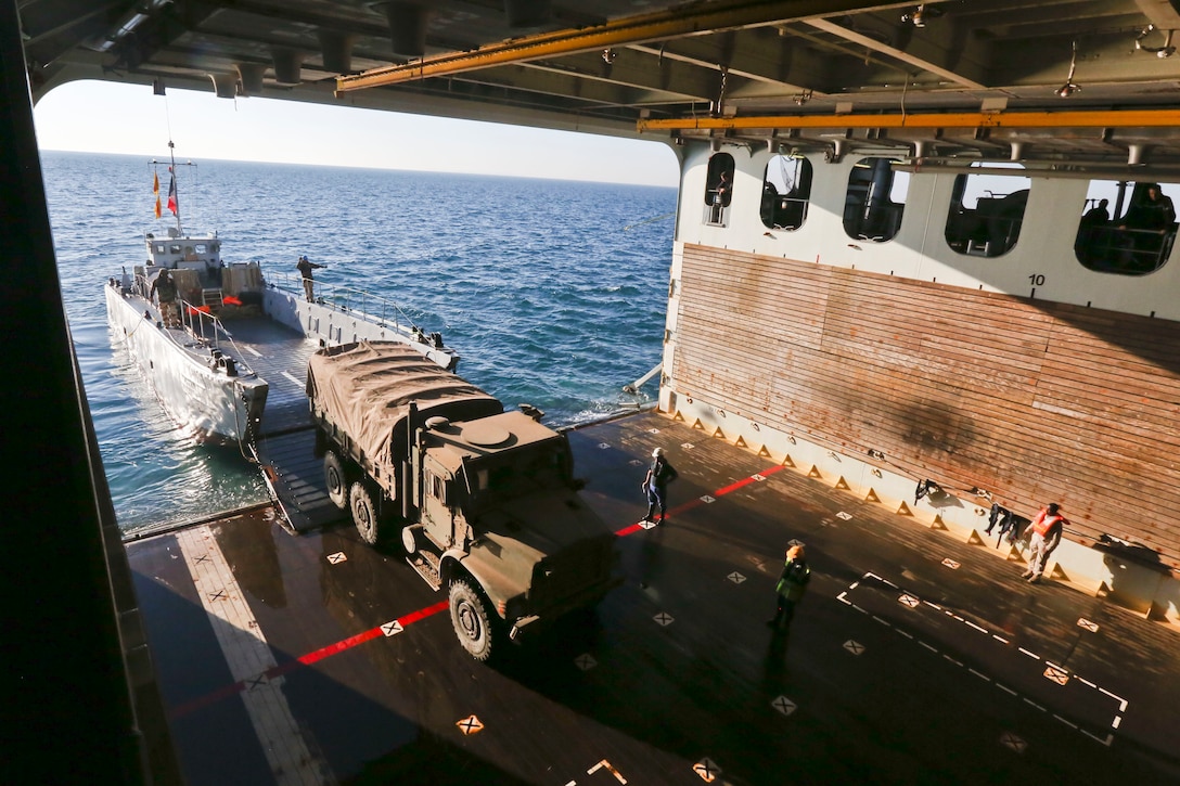 A French landing craft unit transports U.S. Marine Corps medium tactical vehicle replacement trucks during an amphibious offload with French forces aboard French amphibious assault ship LHD Tonnerre (L9014). Tonnerre, with embarked Marines and Sailors from the 15th Marine Expeditionary Unit and Naval Amphibious Force, Task Force 51, 5th Marine Expeditionary Brigade, is conducting maritime security operations within the U.S. 5th Fleet area of operations to ensure regional stability, freedom of navigation and the free flow of commerce.