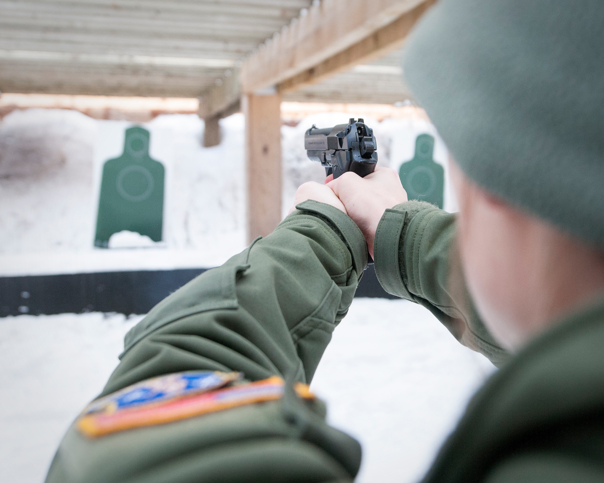 U.S. Air Force Airman with the 109th Aeromedical Evacuation Squadron prepares to fire the M9 Beretta pistol in Coon Rapids, Minn., Feb. 23, 2018.