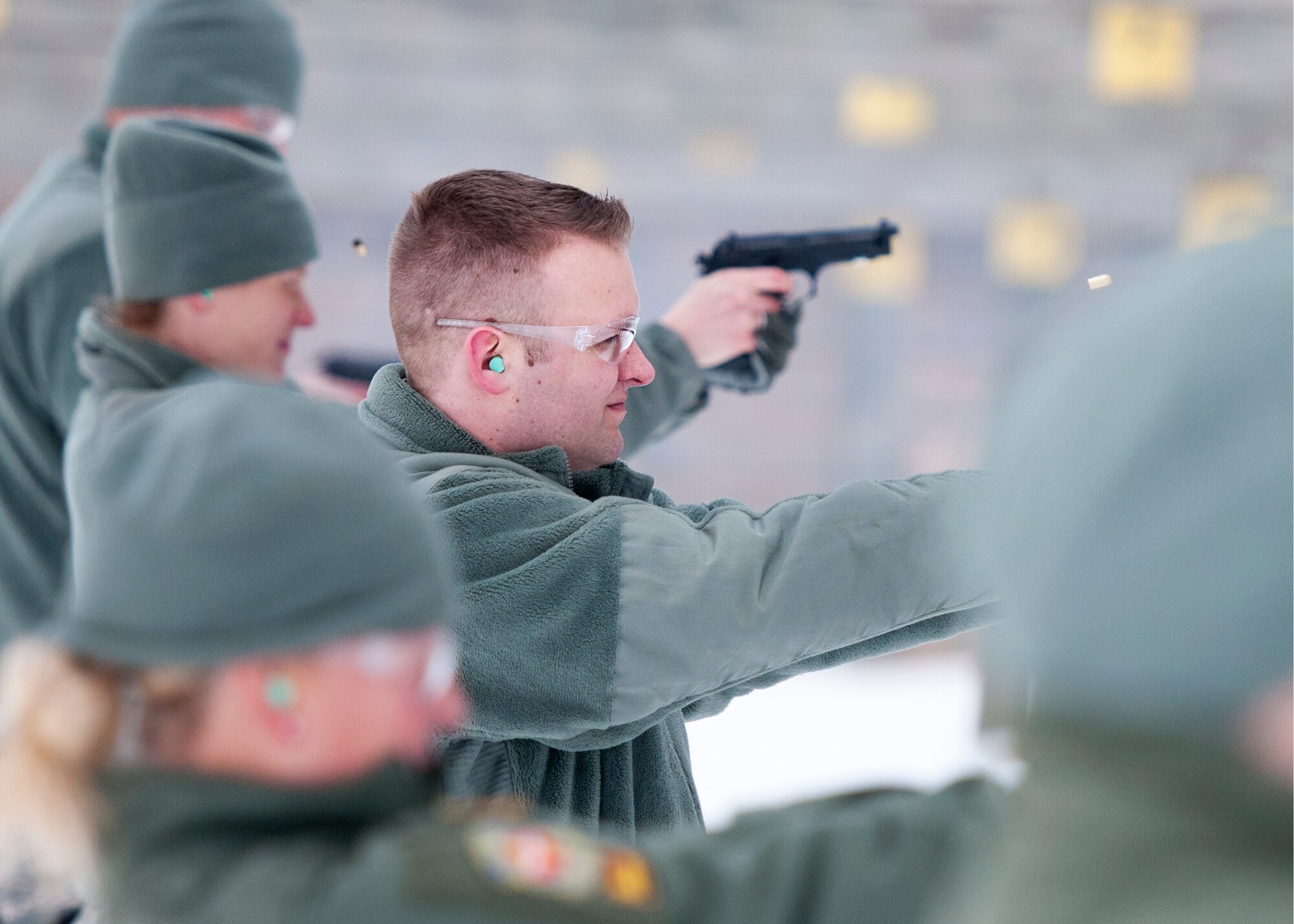 U.S. Air Force Airmen with the 109th Aeromedical Evacuation Squadron fire the M9 Beretta pistol in Coon Rapids, Minn., Feb. 23, 2018.