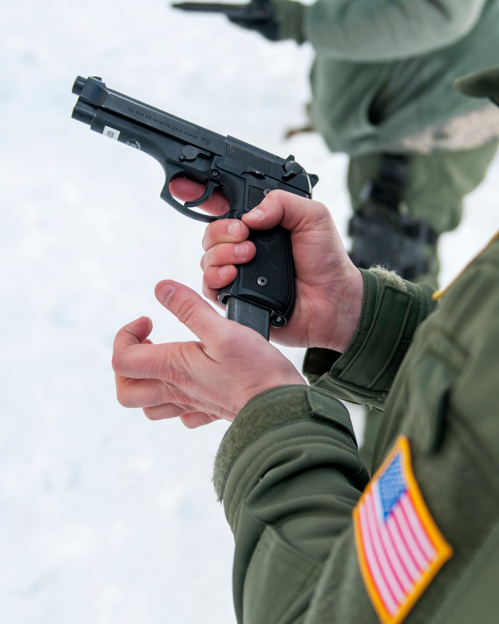 U.S. Air Force Airman with the 109th Aeromedical Evacuation Squadron loads a magazine into an M9 Beretta pistol in Coon Rapids, Minn., Feb. 23, 2018.