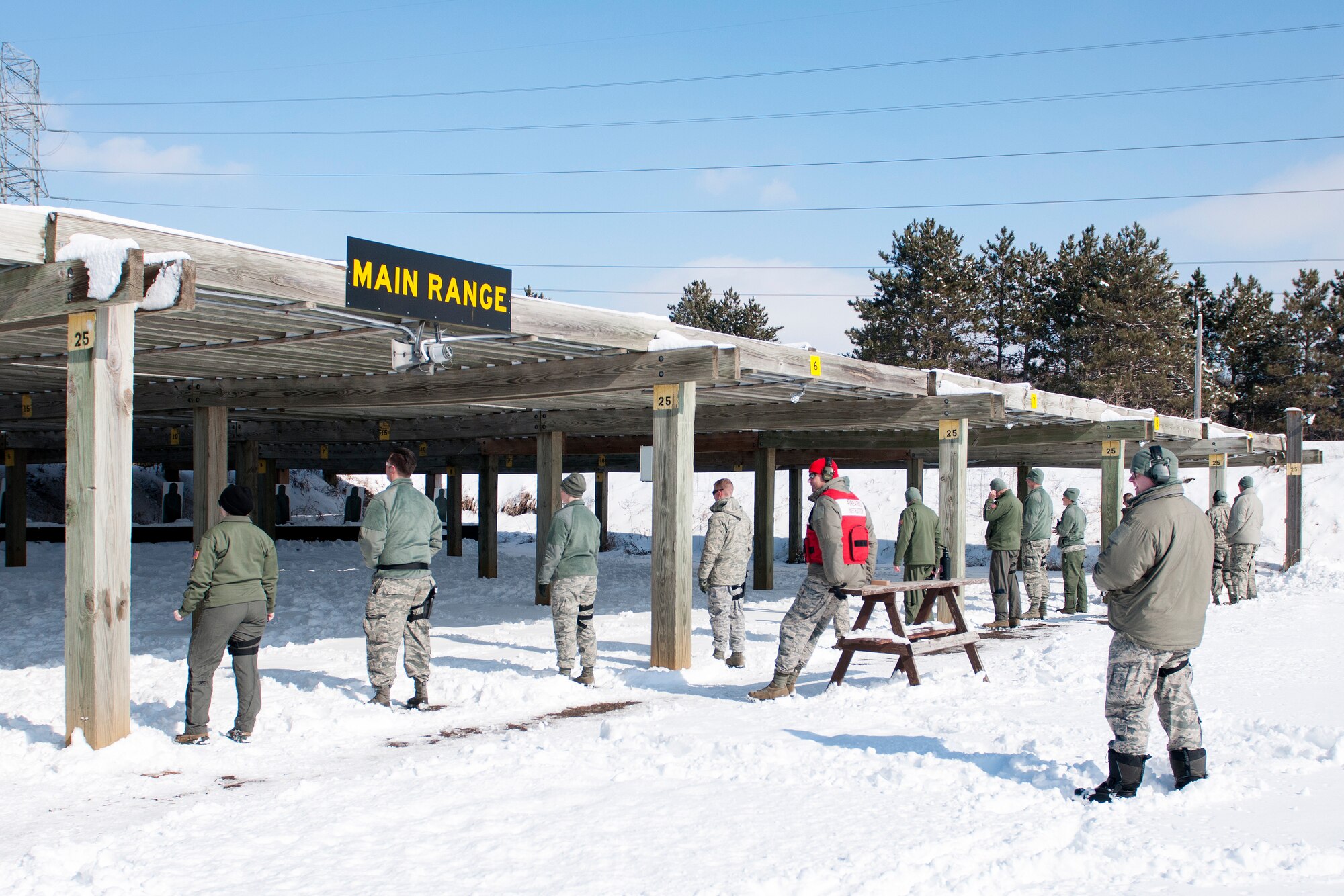 U.S. Air Force Airmen with the 109th Aeromedical Evacuation Squadron wait for the command to fire during a M9 Beretta pistol weapons qualification course in Coon Rapids, Minn., Feb. 23, 2018.