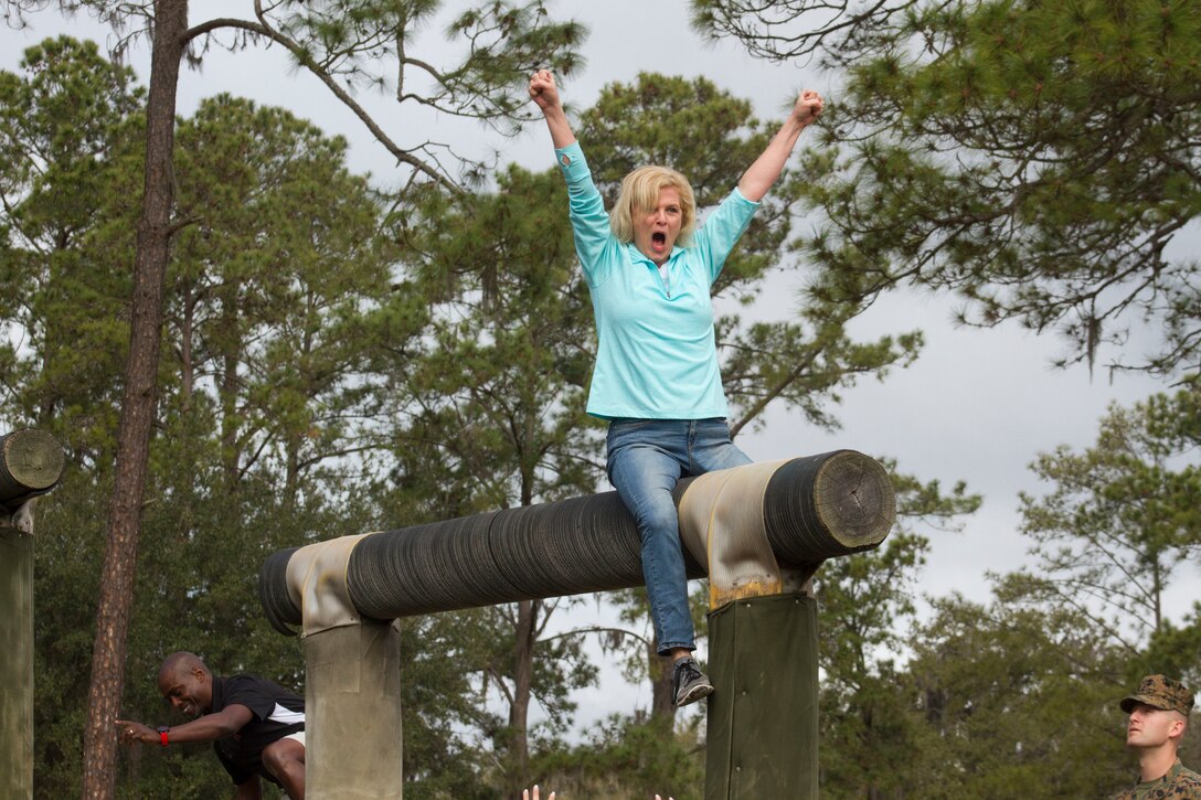 Paula O'Shields, an attendee of the Educators Workshop, cheers after successfully reaching the highest point of an obstacle aboard Marine Corps Recruit Depot Parris Island, South Carolina, Feb. 22, 2018.  These educators traveled from Recruiting Station (RS) Atlanta and RS Jacksonville to experience the workshop. The workshop allows educators to have an inside look at educational benefits and career opportunities in the Marine Corps to better inform their students. (U.S. Marine Corps photo by Cpl. Jorge A. Rosales)