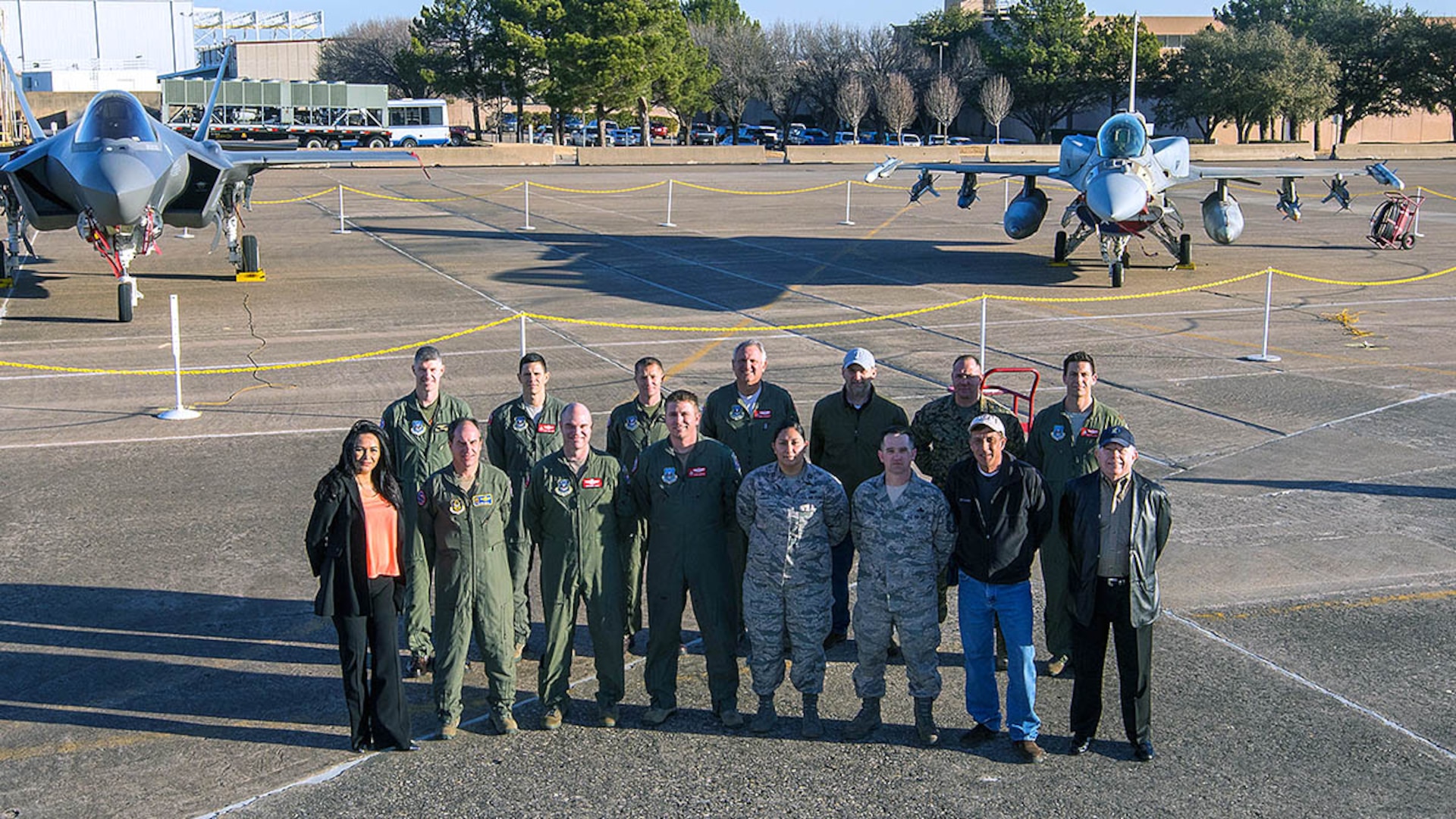 Defense Contract Management Agency Lockheed Martin Fort Worth’s flight operations team is led by Marine Corps Lt. Col. Joe Hutcheson (back row, first from left). The team provides program support and worldwide delivery for the F-35 Lightning II, the F-16 Fighting Falcon and the F-22 Raptor. It is a global effort supported by eight active duty service members, multiple civilians and two Air Force Reserve officers — Lt. Col. Michael Kirk (front row, third from left) and Maj. Kerry McAnally (back row, fourth from left). According to leadership, the pair play a vital role within the mission. (Photo courtesy of Lockheed Martin Aeronautics-Angel DelCueto)