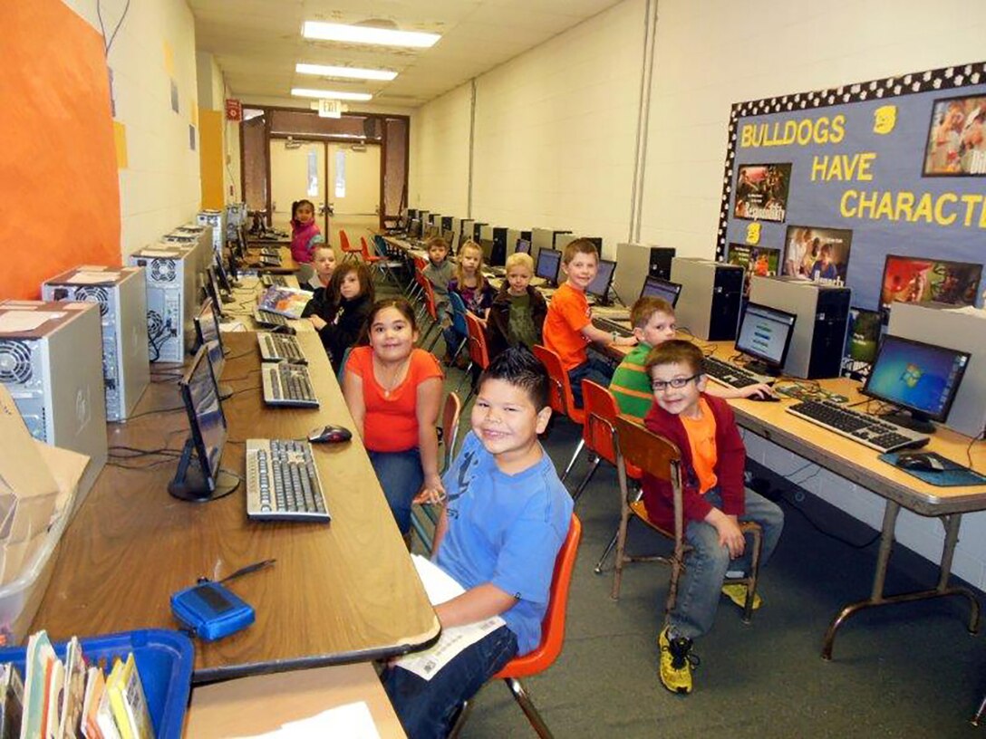 Elementary students in Drummond, Oklahoma, work in their new computer lab. Their district acquired 114 desktop units from Vance Air Force Base via DLA. Older students installed operating systems, drivers, software and network switches to prepare the machines for reuse.