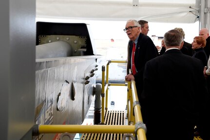 IMAGE: DAHLGREN, Va. (Feb. 22, 2018) – Dr. Hans Mark, former Secretary of the Air Force, looks over the electromagnetic railgun located at Naval Surface Warfare Center Dahlgren Division. Mark and retired Adm. James Hogg were honored during an electromagnetic railgun line naming ceremony. As public servants, Hogg and Mark laid the foundation for the U.S. Navy Railgun Program and led the effort to explore and illustrate to senior leadership the warfighting advantages of this game-changing technology and were pivotal in gaining the initial funding necessary to demonstrate its feasibility. (U.S. Navy photo by John F. Williams/Released)